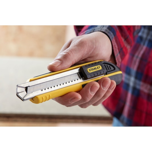 STANLEY 0-10-481 utility knife with segmented blade held in hand, yellow and black design.