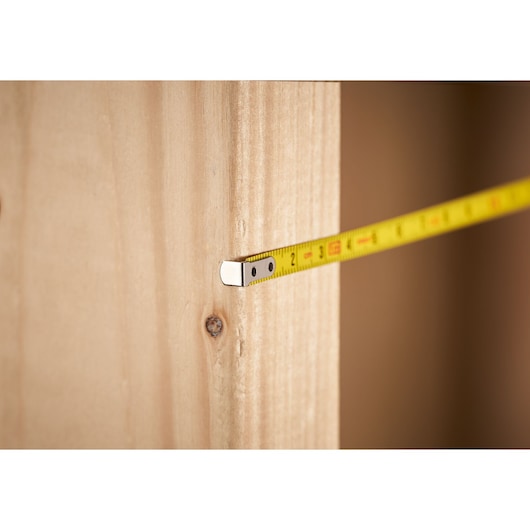 STANLEY 0-39-055 tape measure measuring wooden board, close-up photo