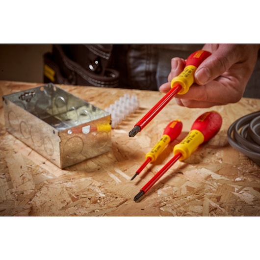 STANLEY 0-65-419 insulated screwdriver set with red and yellow handles in electrical workspace.