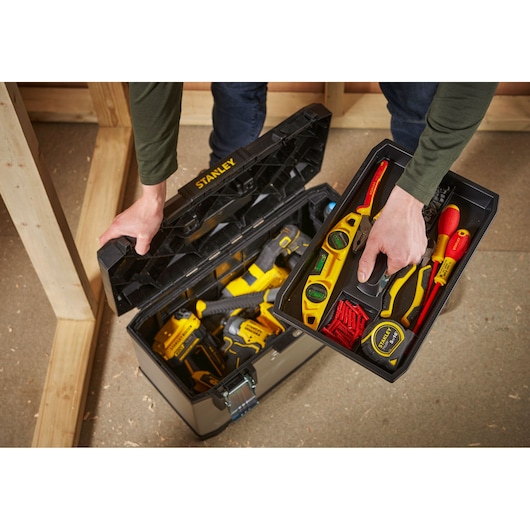 STANLEY 1-95-616 tool box opened, showing organized hand tools and power tools, photographed from above.