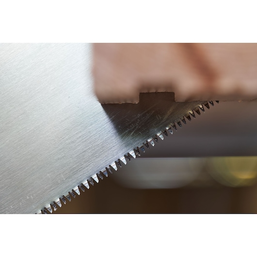 STANLEY 2-15-244 saw blade close-up showing sharp teeth cutting through wood, product photography.