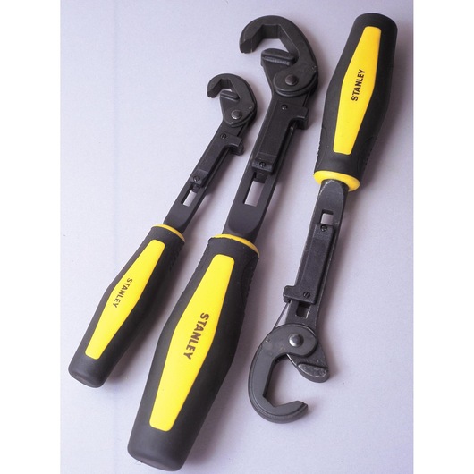 STANLEY 4-87-988 set of three adjustable wrenches with black metal jaws and yellow-black handles, angled view.