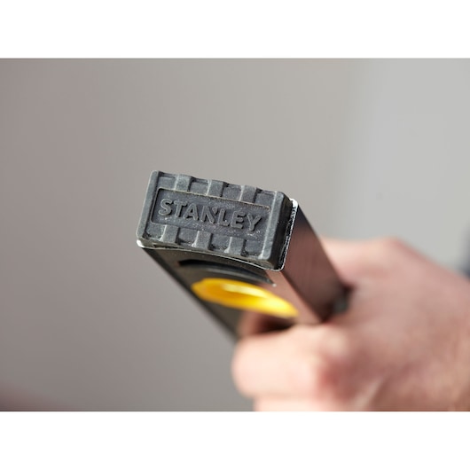 Photo of STANLEY FMHT42562-1 level tool end with textured rubber cap and brand logo, close-up view.