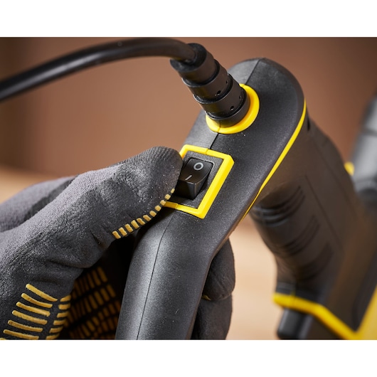 STANLEY FMHT6-75934 hand tool close-up showing power switch and cable with glove.