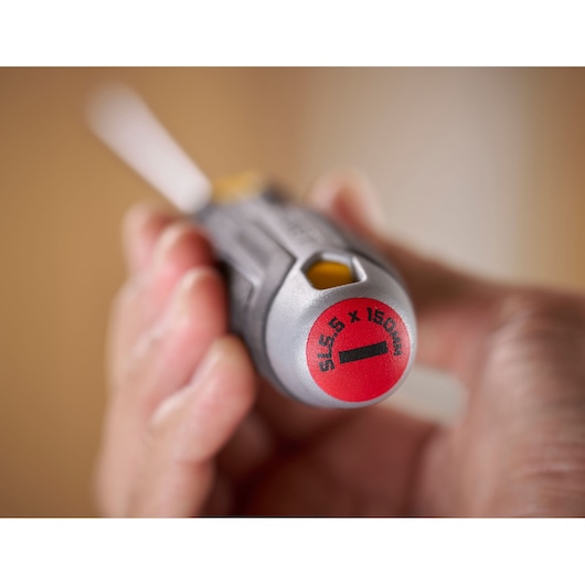 Close-up of a hand holding a STANLEY slotted screwdriver, 5.5 x 150 mm, focus on handle end.