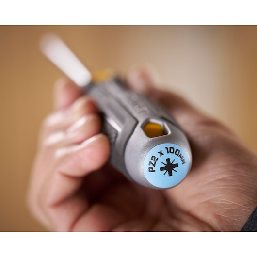 Close-up of a hand holding a Stanley screwdriver, showing the PZ2 x 100mm marking on the handle end.
