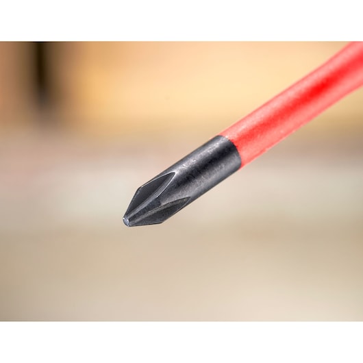 Close-up of a Phillips screwdriver tip with a red handle, used for driving screws.