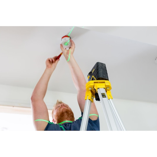 Photo of STANLEY FMHT77598-1 laser level tripod being used for ceiling installation.