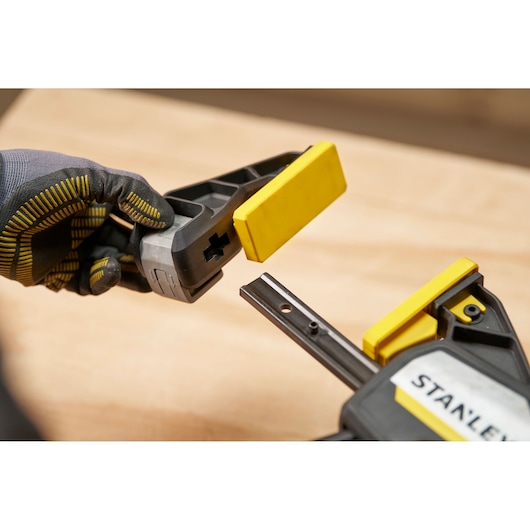 STANLEY FMHT83282-0 photography of quick clamp with removable yellow pad, close-up angle.