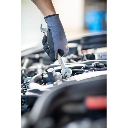 STANLEY FMMT13071-0 combination wrench in use on car engine, close-up photography.