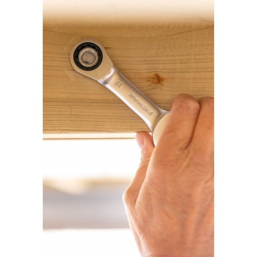 Photo of STANLEY FMMT13115-0 ratcheting wrench being used to tighten a bolt on wood.