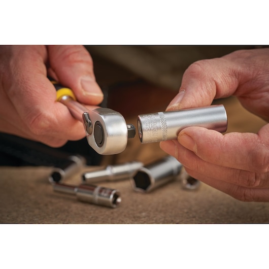 STANLEY FMMT17338-0 ratchet handle with socket, close-up view, silver tool parts on table.