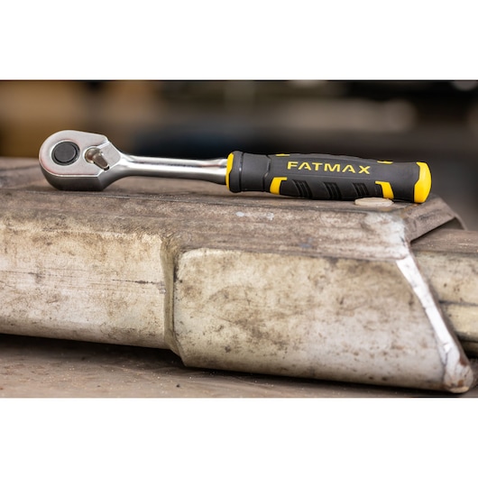 STANLEY FMMT82677-0 ratchet with black and yellow FATMAX handle on metal surface.