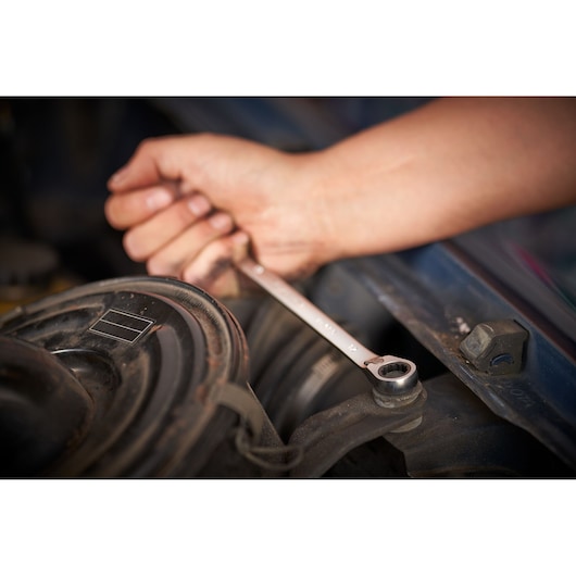 STANLEY FMMT82848-0 ratcheting wrench in use on automotive part, STANLEY FATMAX 7-piece set.