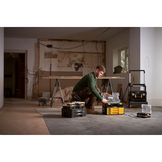 STANLEY FMMT98107-1 tool storage boxes in use at a construction site, various sizes shown.