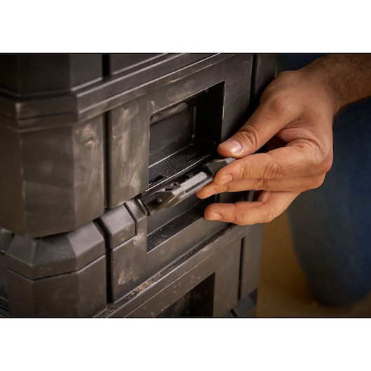 Photo of STANLEY FMST1-71967 toolbox latch being operated by hand, close-up view.