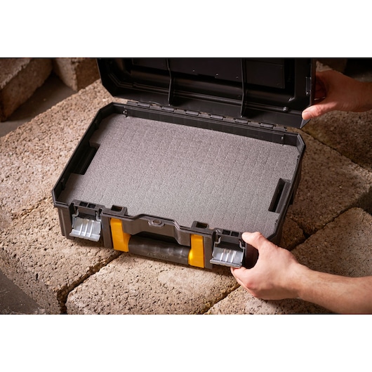 STANLEY FMST1-71967 tool case with foam insert, black and yellow, open on stone surface, top angle.