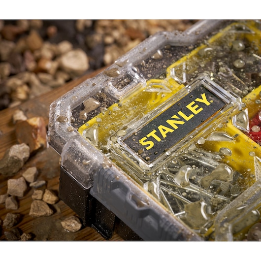 STANLEY FMST1-75779 organizer with water droplets on transparent lid, close-up view, yellow and black design.