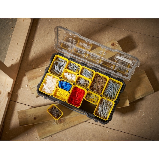 STANLEY FMST1-75779 organizer box with yellow compartments filled with assorted fasteners, top view.