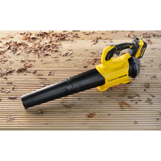 STANLEY SFMCBL730M1 cordless leaf blower on a wooden deck, yellow and black design, lateral view.