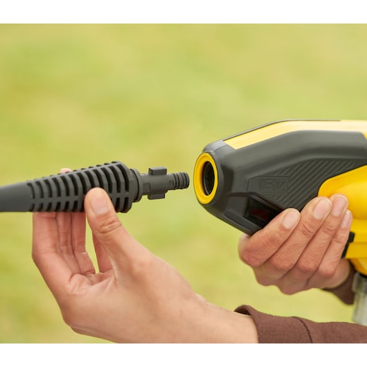 STANLEY SFMCPC93B portable washer nozzle connection, close-up, yellow and black housing in hand.