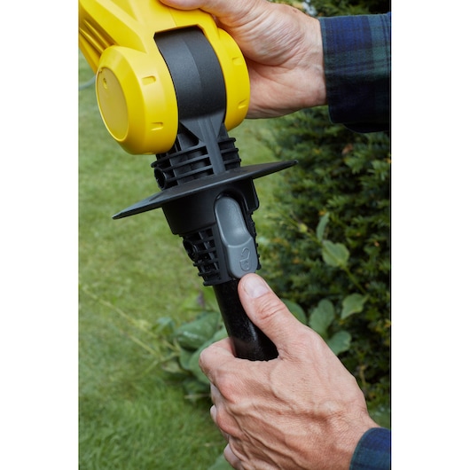 STANLEY SFMCPH845B trimmer handle adjustment close-up in use, showing yellow and black design.