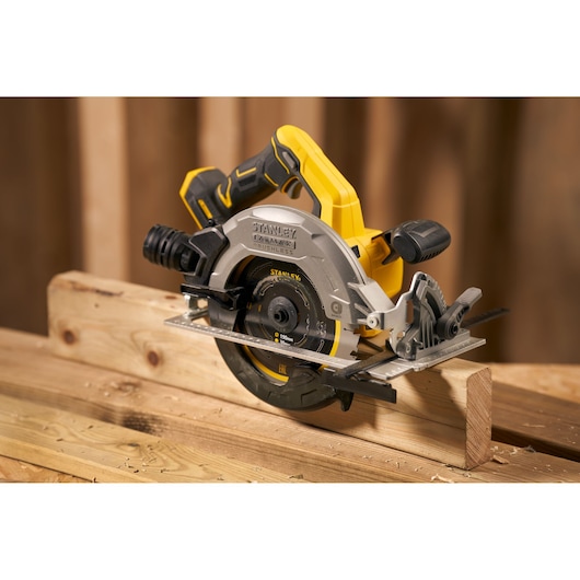 Photo of STANLEY SFMCS550B cordless circular saw cutting wood, yellow and black design, woodworking setting.