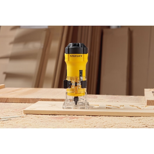 STANLEY ST55-KR compact wood router on workbench, yellow and black, front angle, woodworking tool.