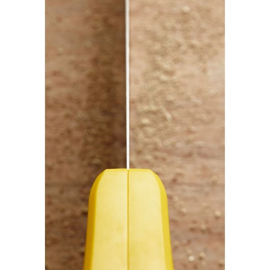 STANLEY STHT20355-1 handsaw with yellow handle, top view, blade cutting through wood.