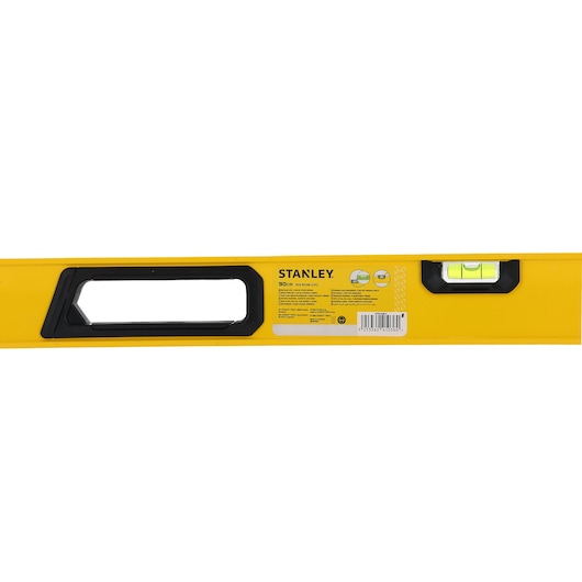Close-up image of a yellow Stanley spirit level, showing the handle, information label, and bubble vial.