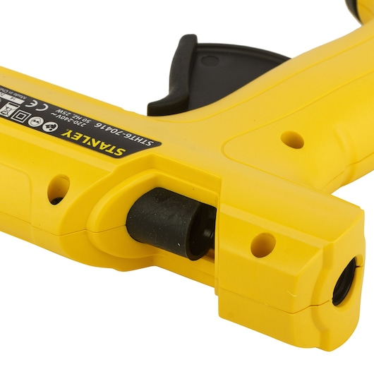 STANLEY STHT6-70416 yellow glue gun close-up, showing nozzle and trigger, angled on white background.