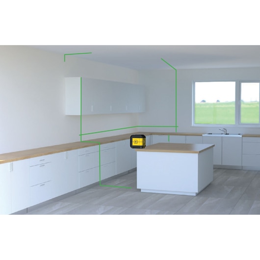 STANLEY STHT77592-1 laser level placed on kitchen island, projecting green lines across white cabinets.