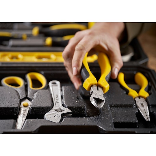 STANLEY STHT78050-1 tool kit close-up with yellow-handled pliers, scissors, and wrench in black tray.