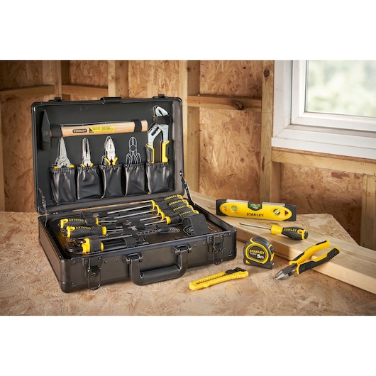 STANLEY STMT72986-1 tool kit with assorted hand tools and yellow-black accents on a wooden workbench.