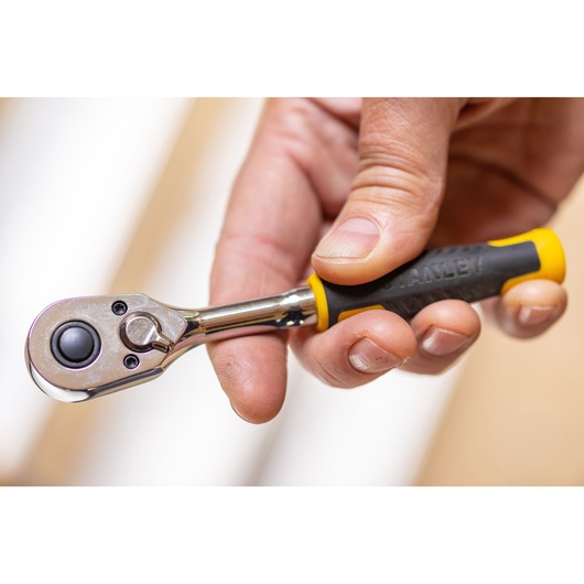STANLEY STMT82663-0 ratchet wrench with black and yellow handle, close-up held in hand.