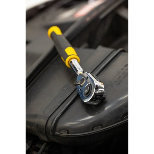 Photo of STANLEY STMT82664-0 ratchet wrench with yellow and black handle on a dark surface.