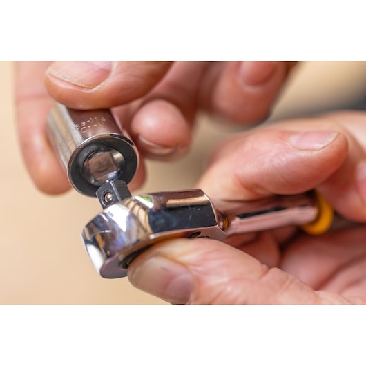 STANLEY STMT86314-0 ratchet wrench with socket, close-up, held in hand, silver finish.
