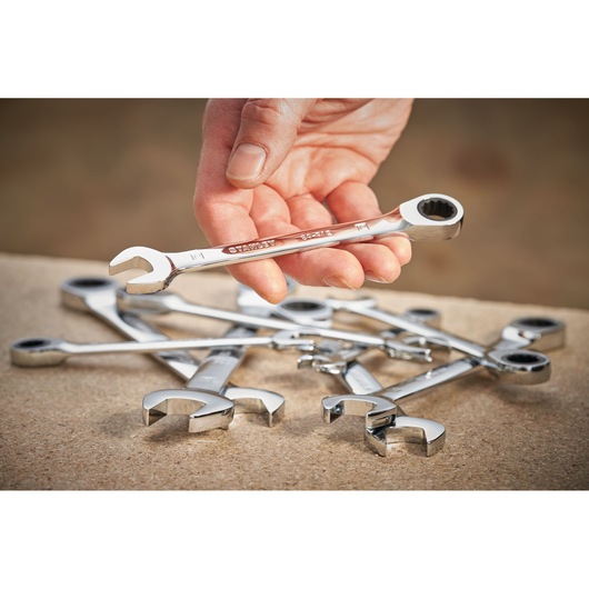STANLEY STMT89911-0 ratcheting spanner set shown on a workbench, one spanner held in hand.
