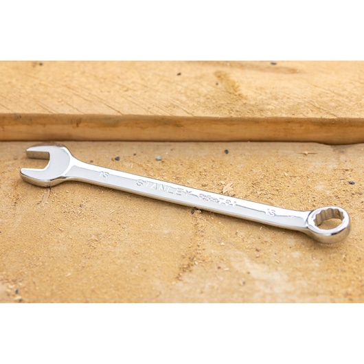 STANLEY STMT95792-0 combination wrench, chrome finish, shown on a wooden surface, perspective view.