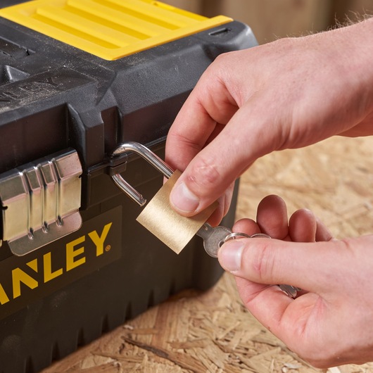 Photo of STANLEY STST1-75518-KR toolbox with padlock being unlocked, close-up view.