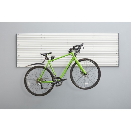 STANLEY STST82615-1 wall storage panel with green road bike mounted on hooks, front view.