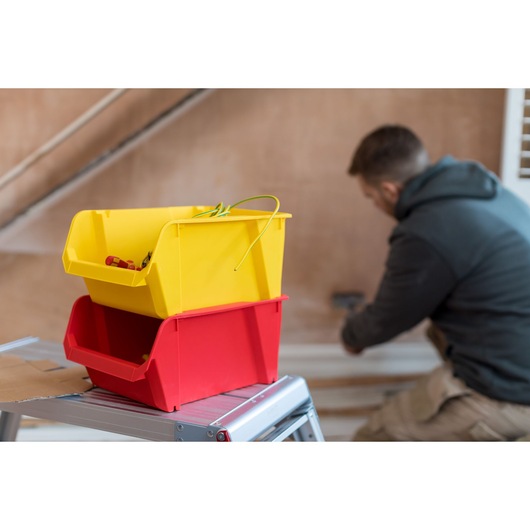 STANLEY STST82742-1 photography of yellow and red storage bins on metal step ladder indoors.