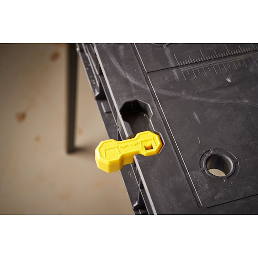 STANLEY STST83492-1 black workbench top with yellow plastic accessory, close-up photography.